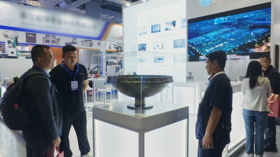 Large metal additive cover-vessel blank displayed under glass on a pedestal