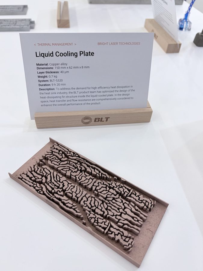 Copper additive liquid cold plate blank with maze-fin zones on a show table