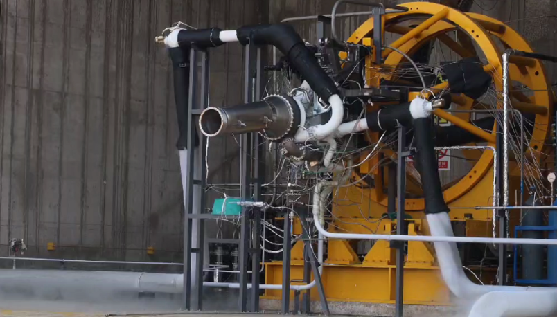 Metal AM propulsion chamber mounted on yellow aerospace test stand