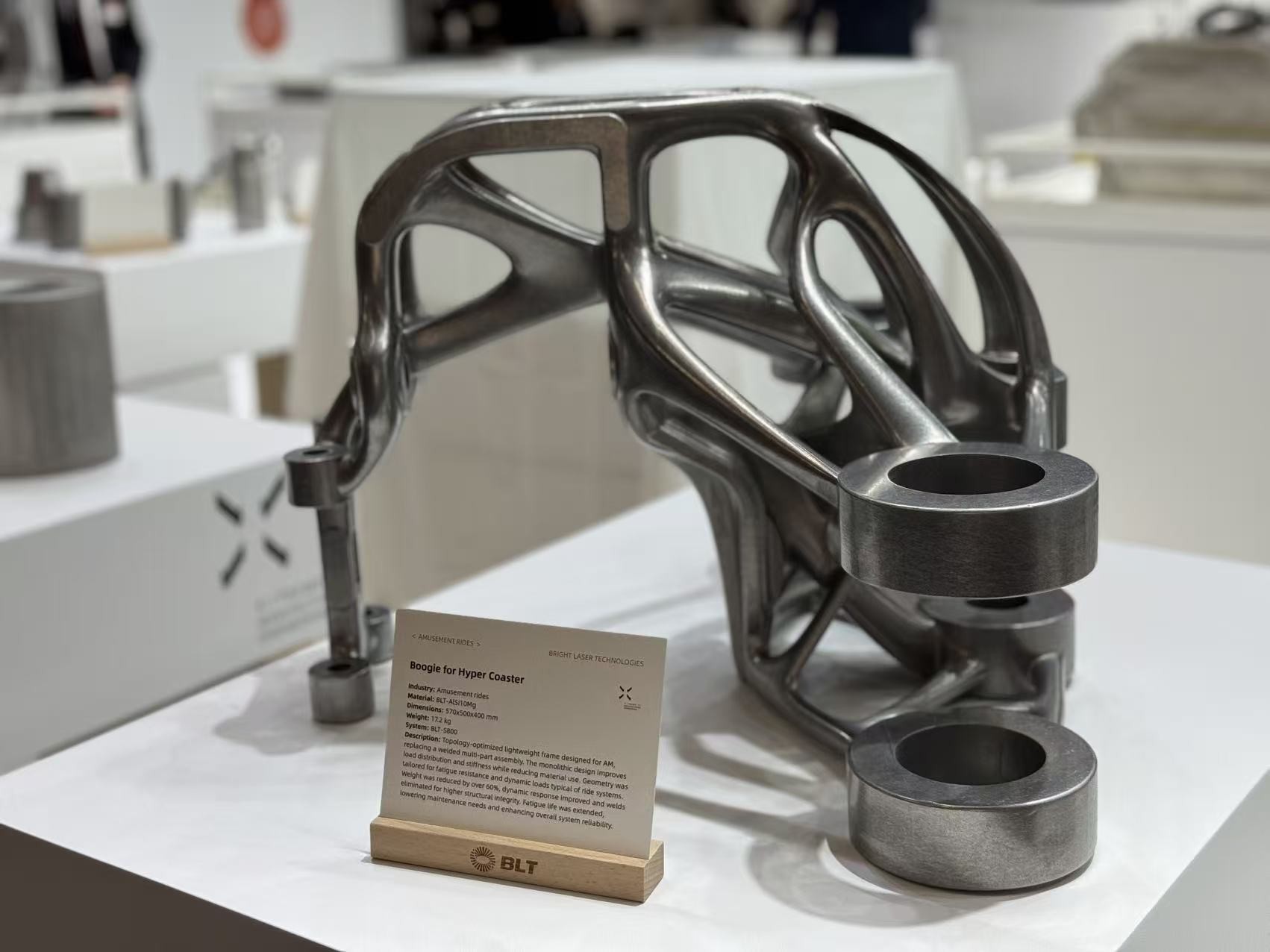 Topology-optimized metal AM hyper-coaster bogie frame on exhibition stand