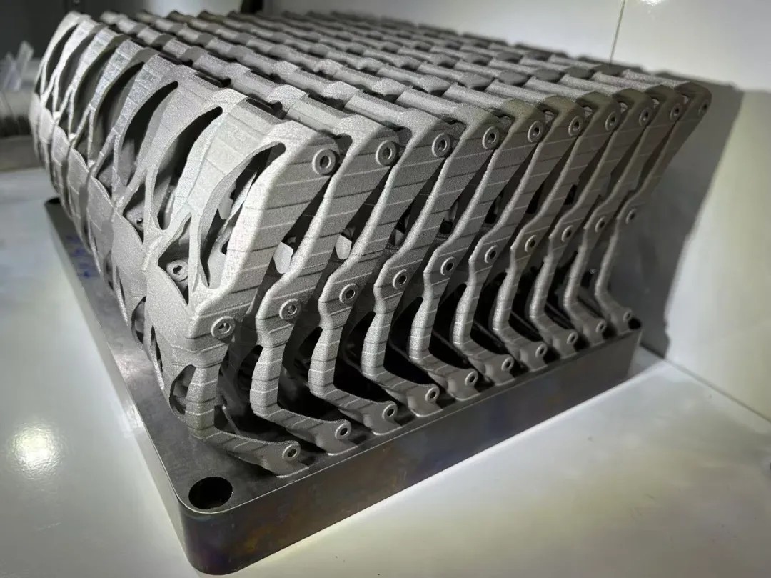 Dense nest of identical metal AM industrial parts still on the build plate