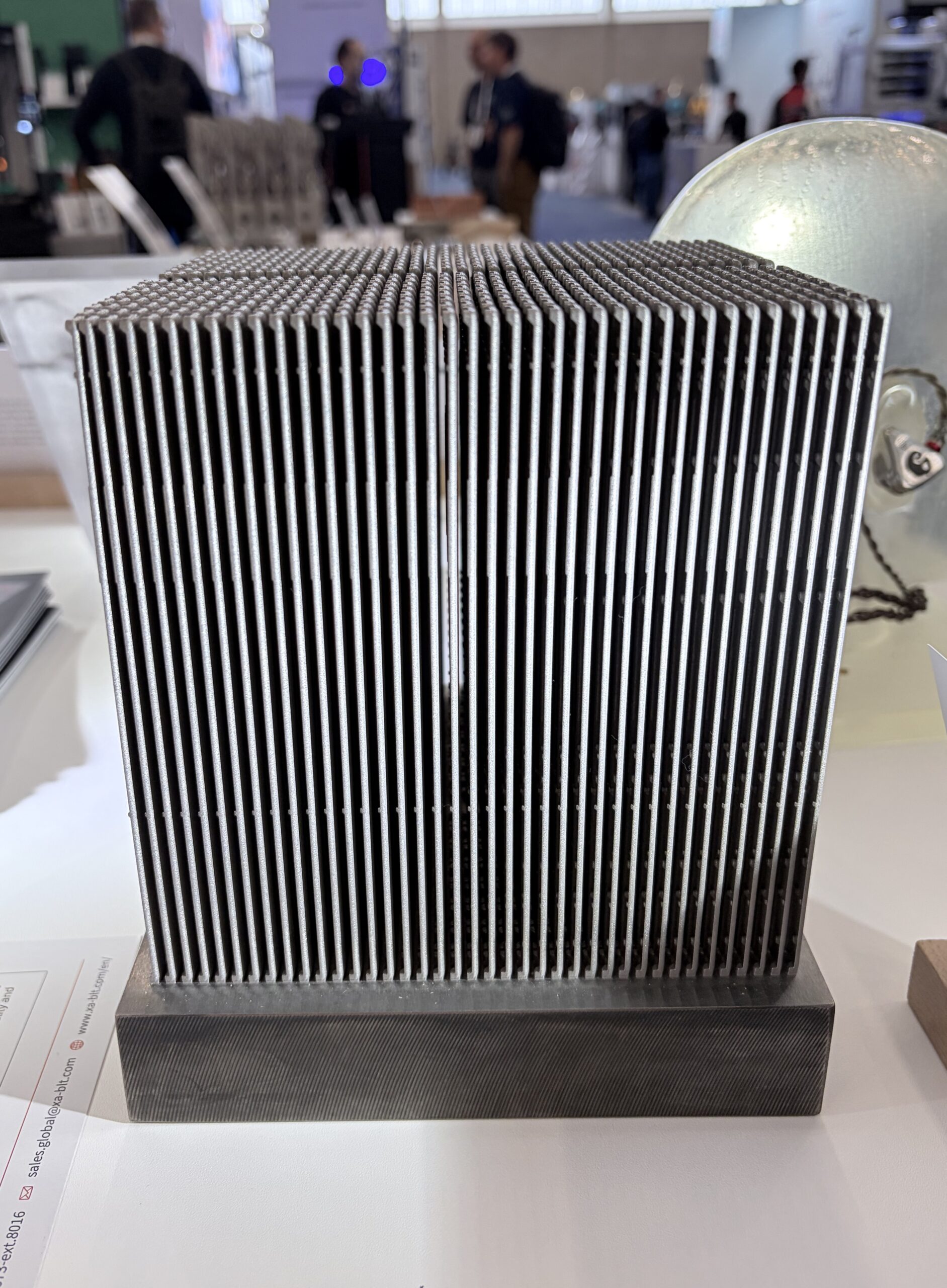 Dense vertical-fin metal additive heat sink on a solid base plate